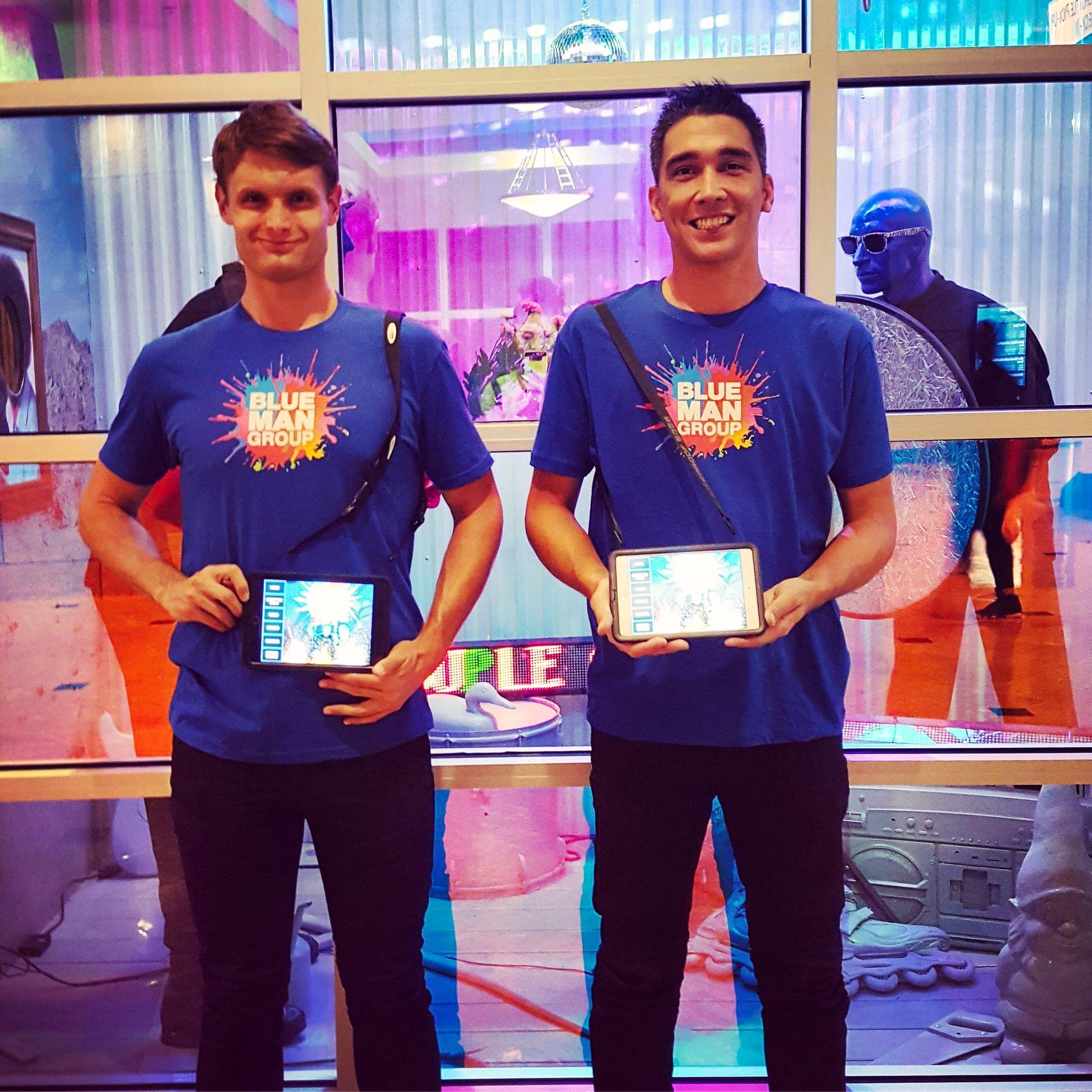 Brand ambassadors posing with Blue Man Group merchandise.