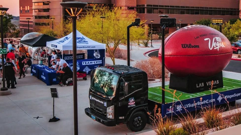 Super Bowl event promotion with giant football display.
