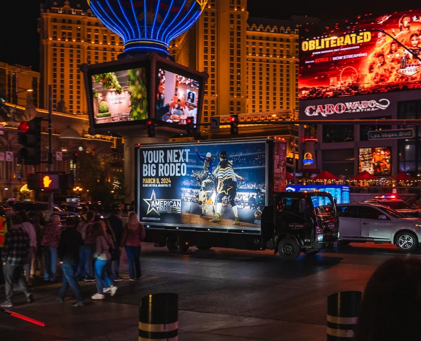 Illuminated billboards and Las Vegas nightlife traffic.