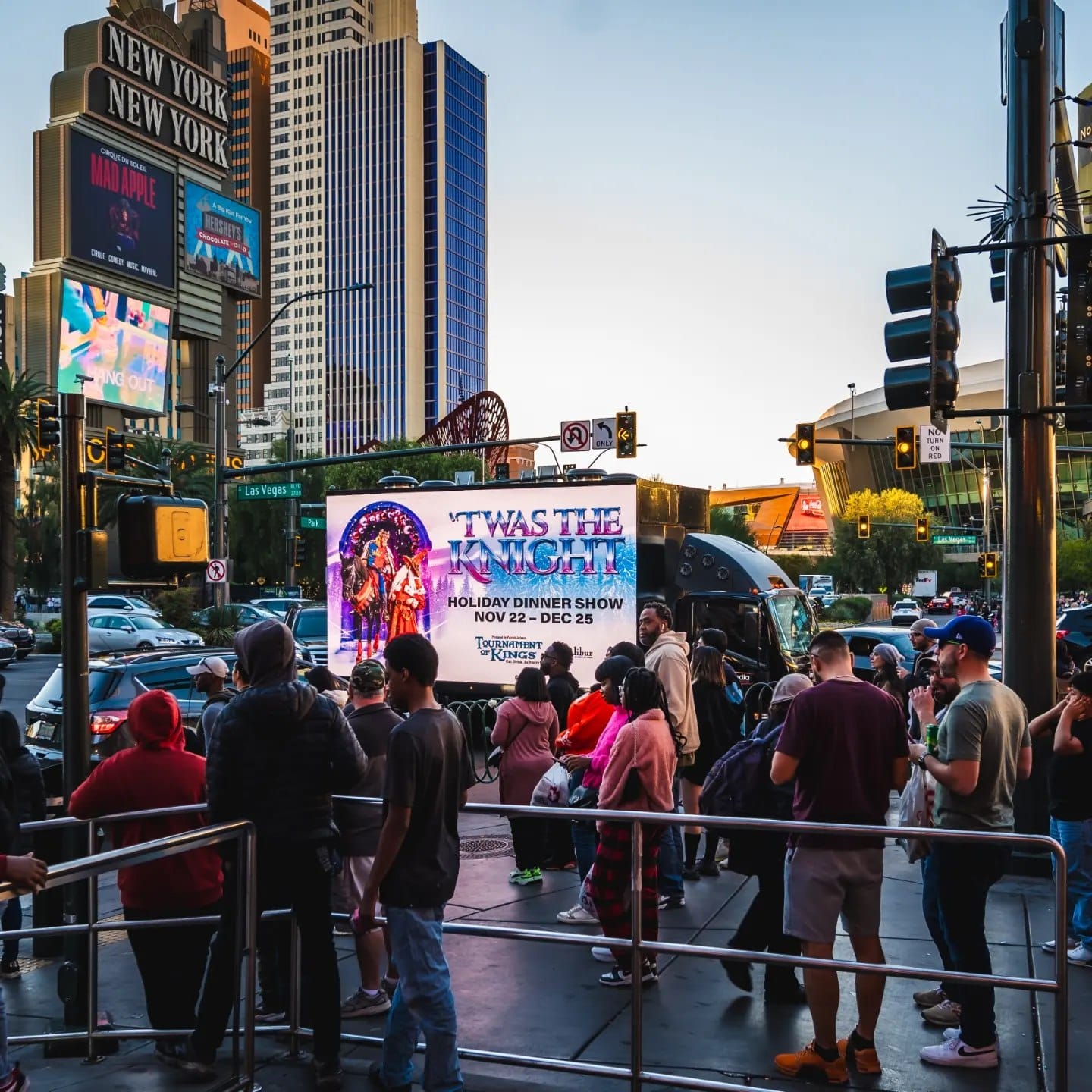 Crowd near Las Vegas show advertisement.