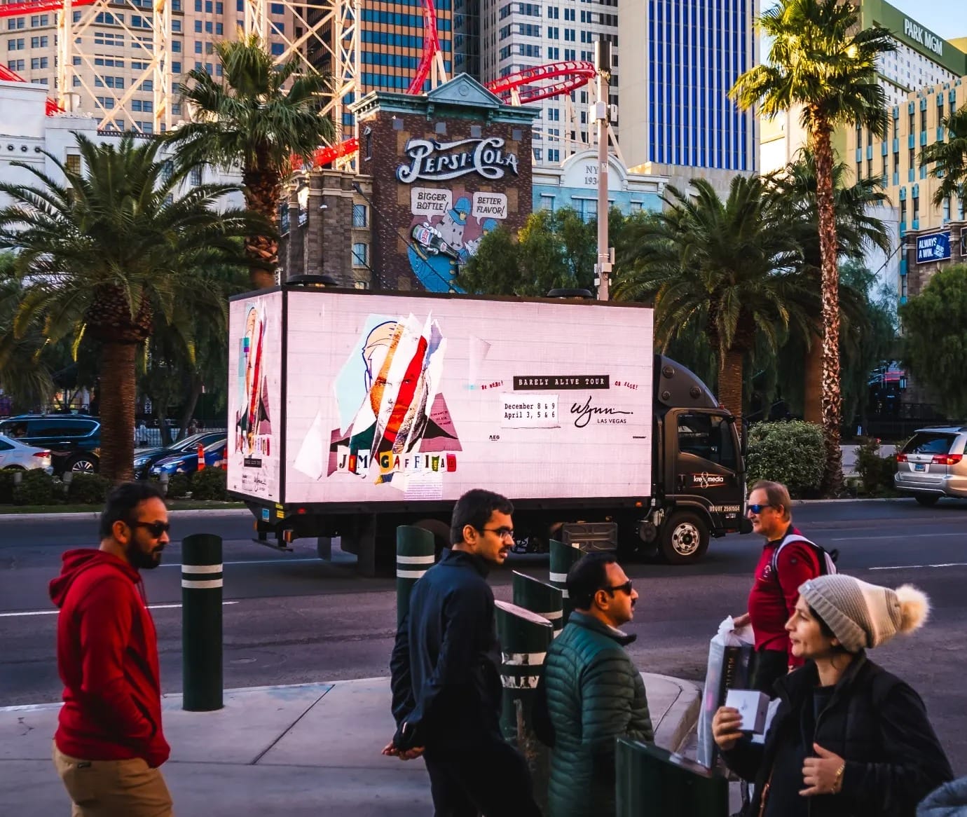 People walking near Las Vegas billboard truck.