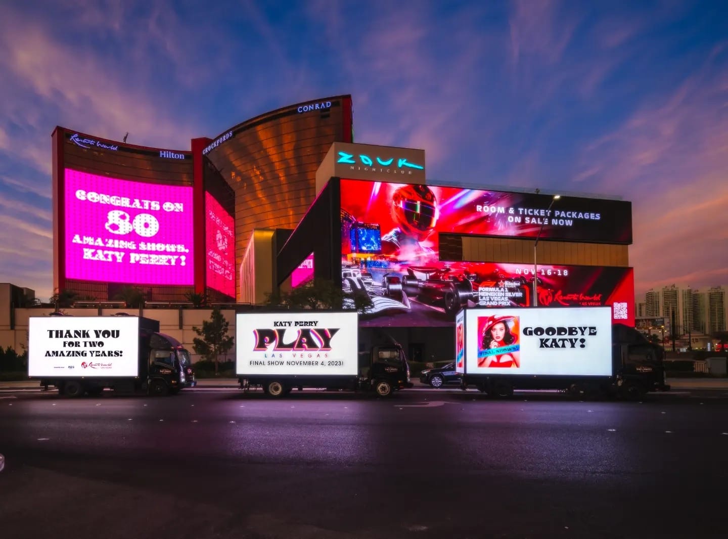 Las Vegas billboards and truck with advertisements at dusk.