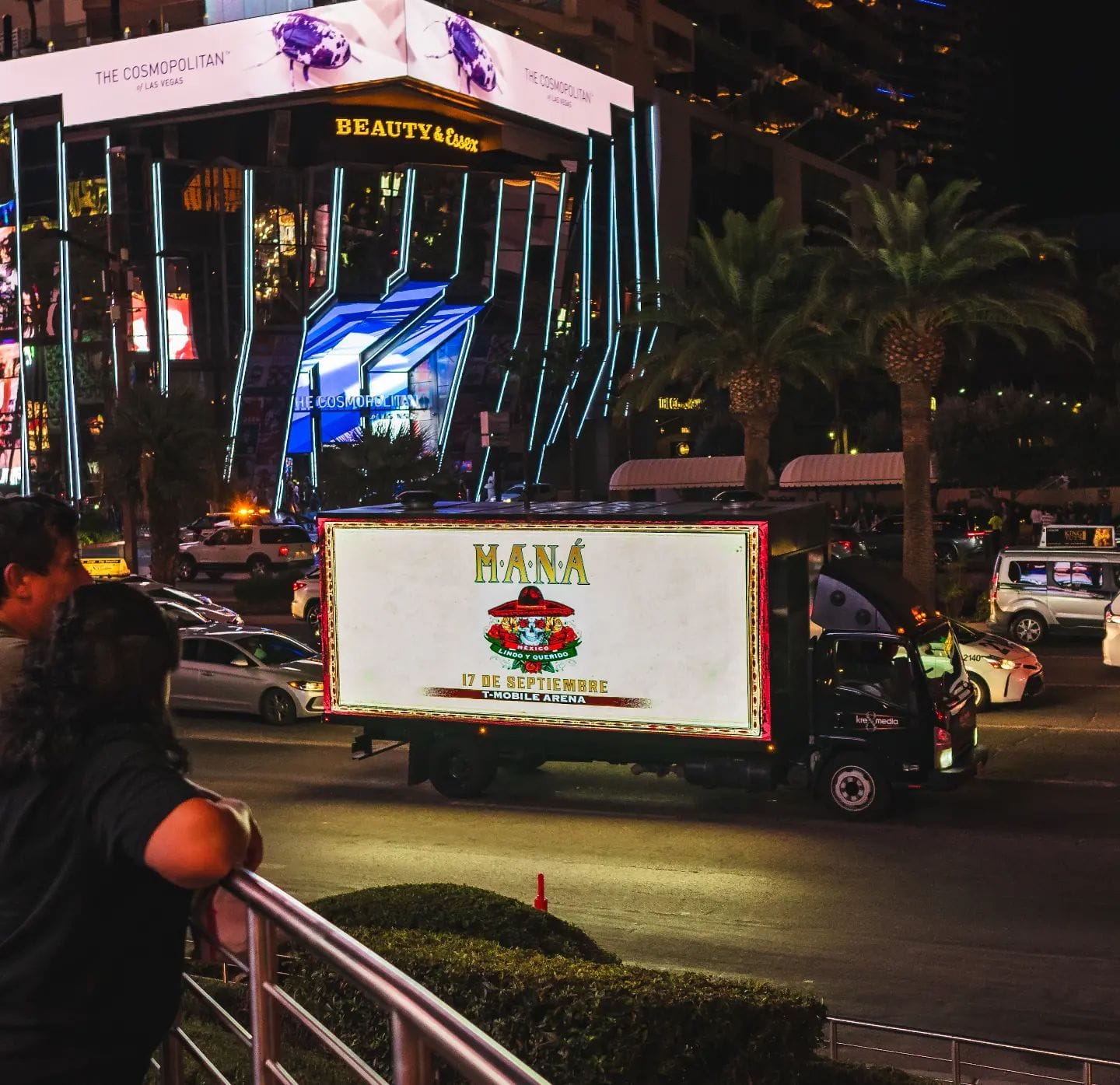 Vegas street view with illuminated advertising truck at night.