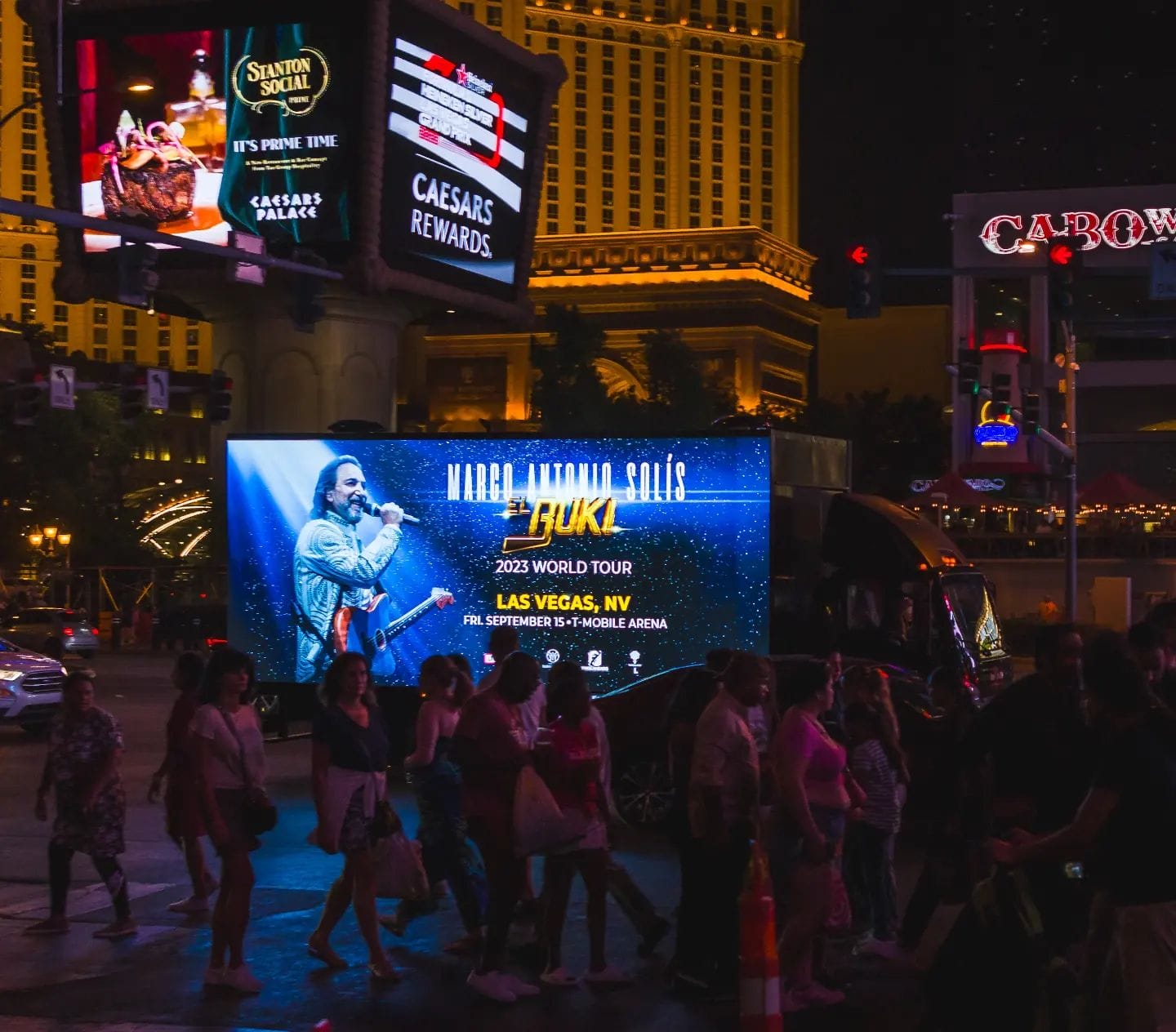 Las Vegas street with concert advertisement billboard at night.