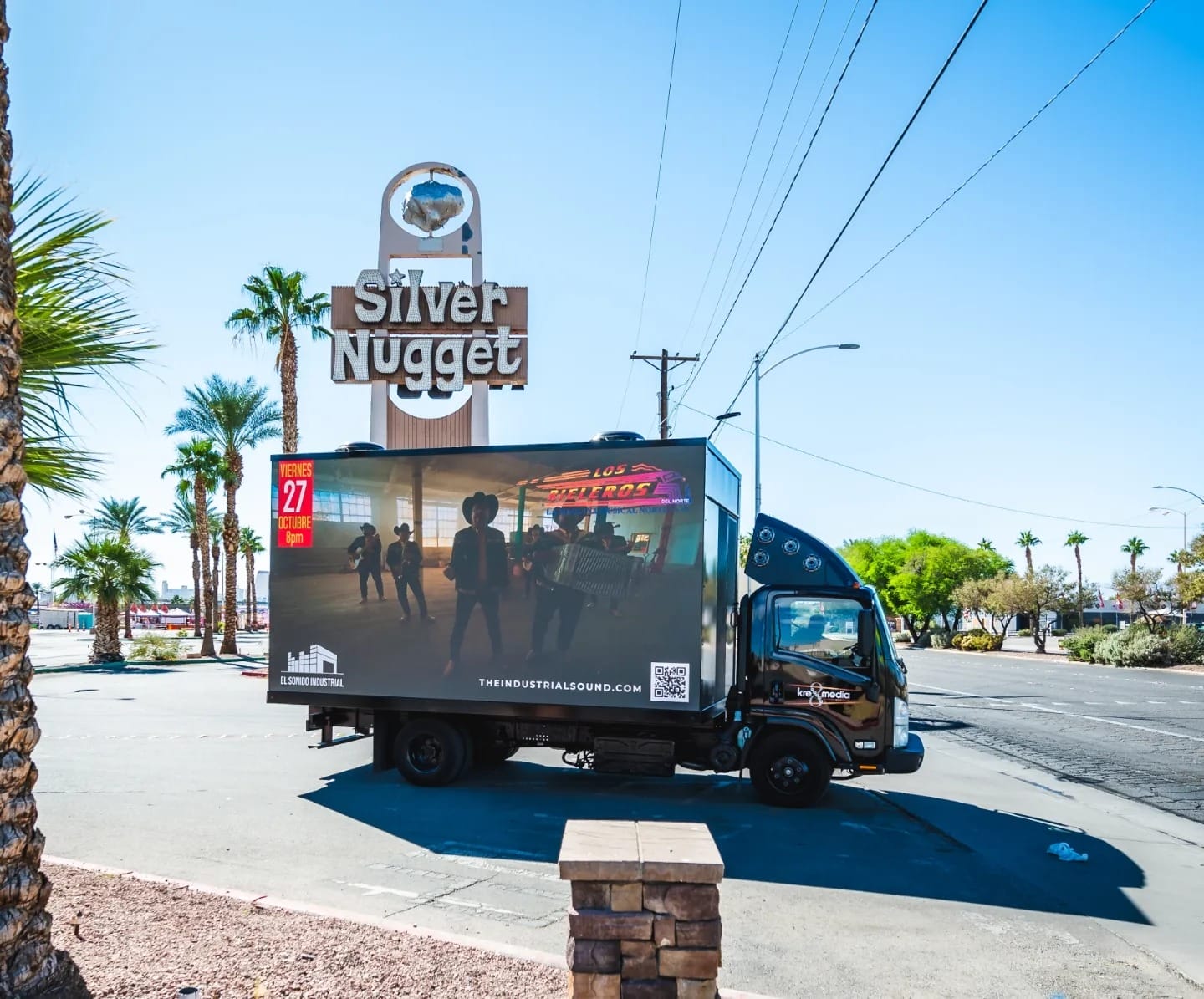 Mobile billboard truck near Silver Nugget sign.