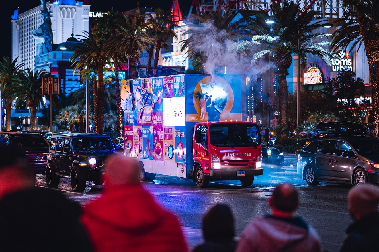 Vibrant Las Vegas Strip night with illuminated advertising truck