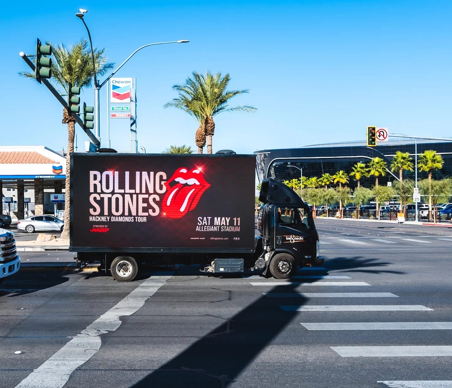 Rolling Stones tour truck advertisement on sunny street