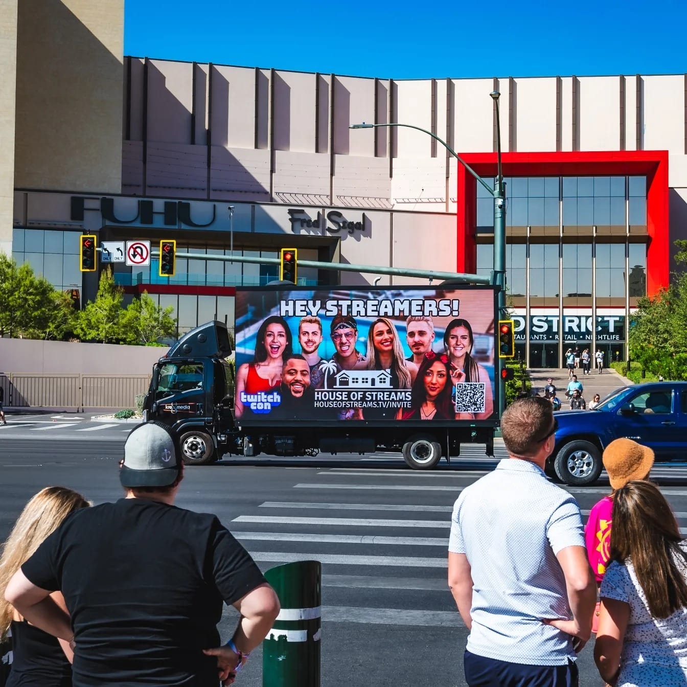 Mobile billboard advertising Twitch Con streams on city street.