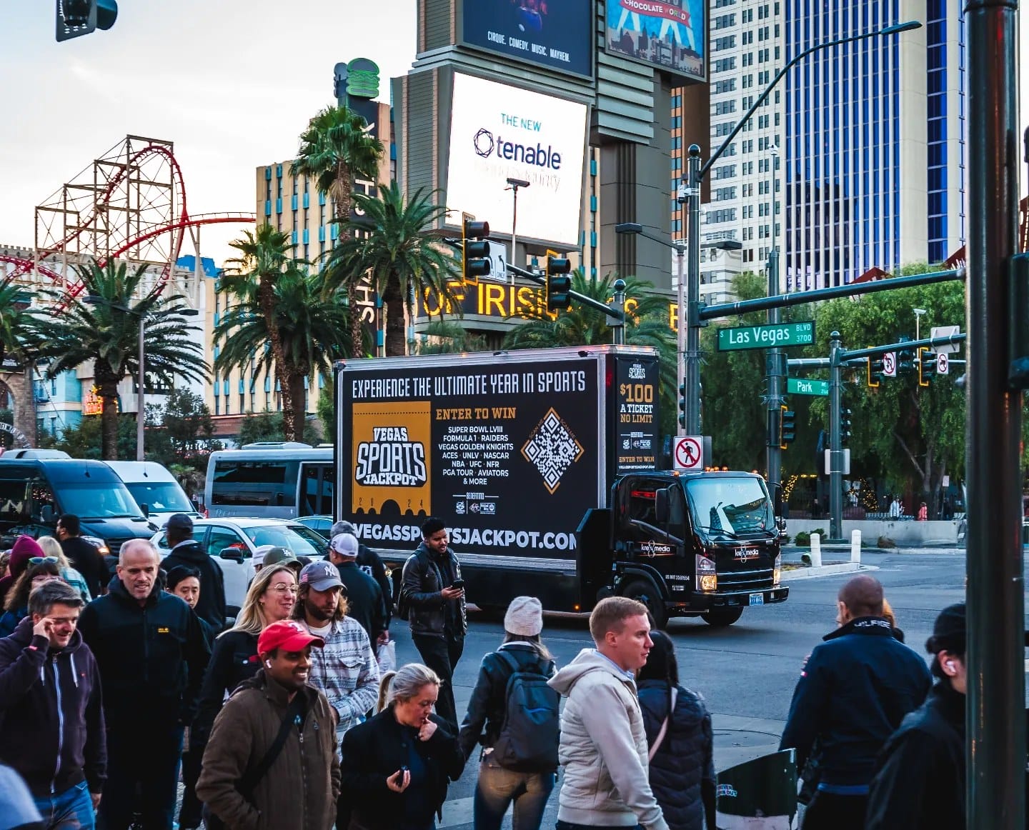 Crowded Las Vegas street with advertising billboards.