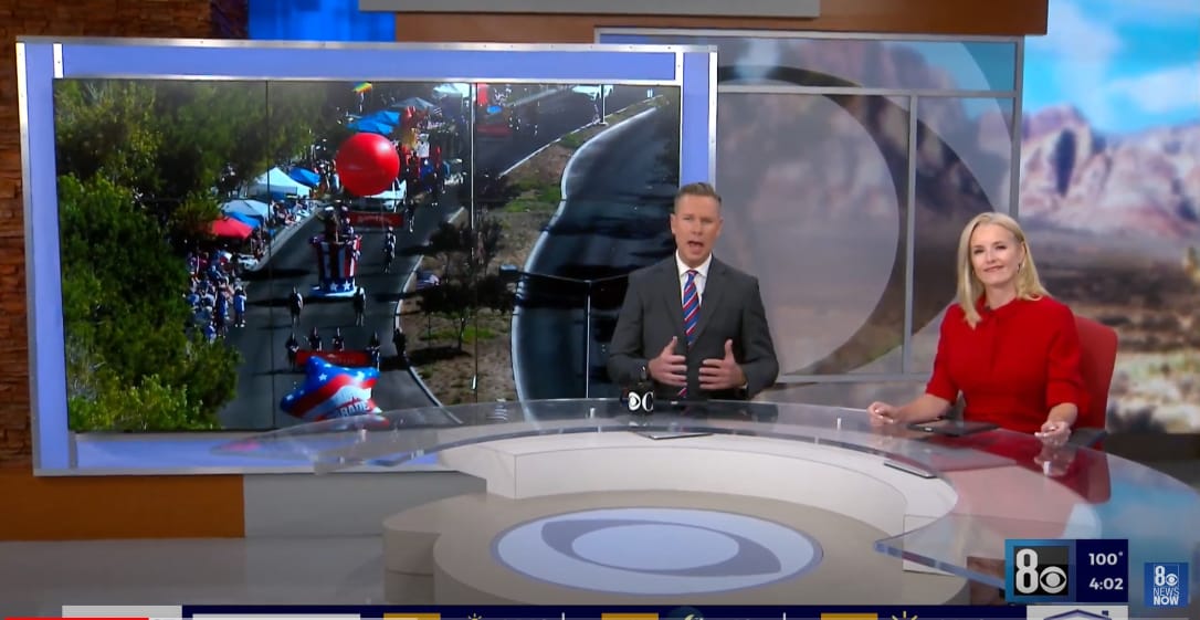 8News Las Vegas News anchors discussing parade footage in a studio