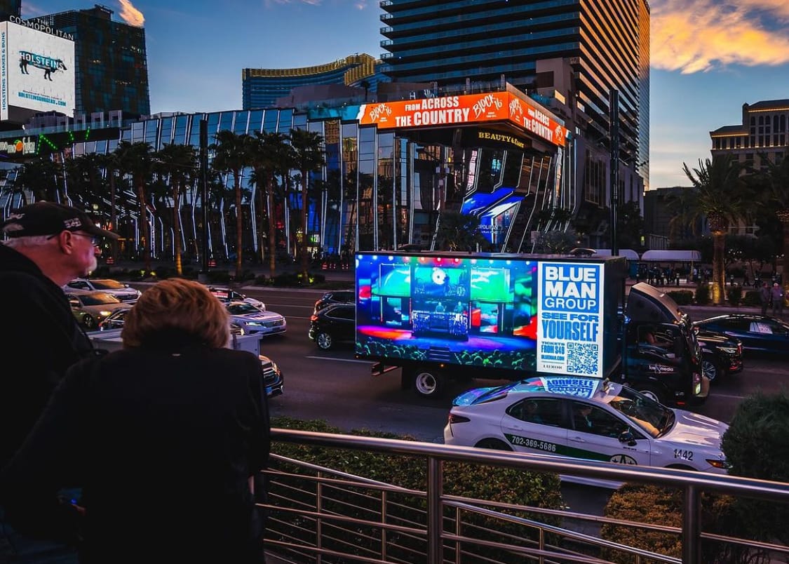 Las Vegas street view with digital advertising truck. Blue Man Group